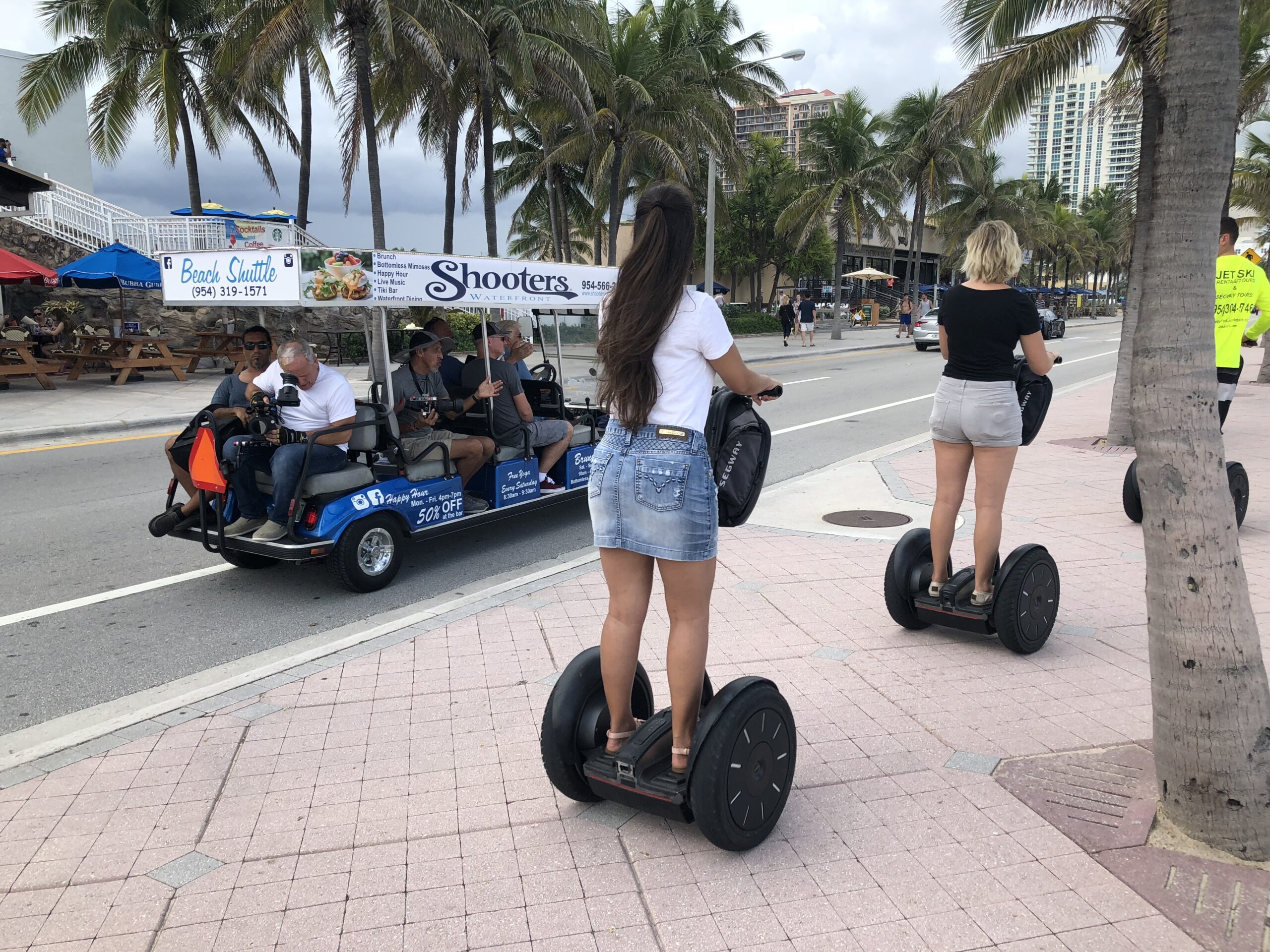 LP Media Fort Lauderdale Campaign Street filming in a golf cart, on the sidewalk there are 3 people on a Segway