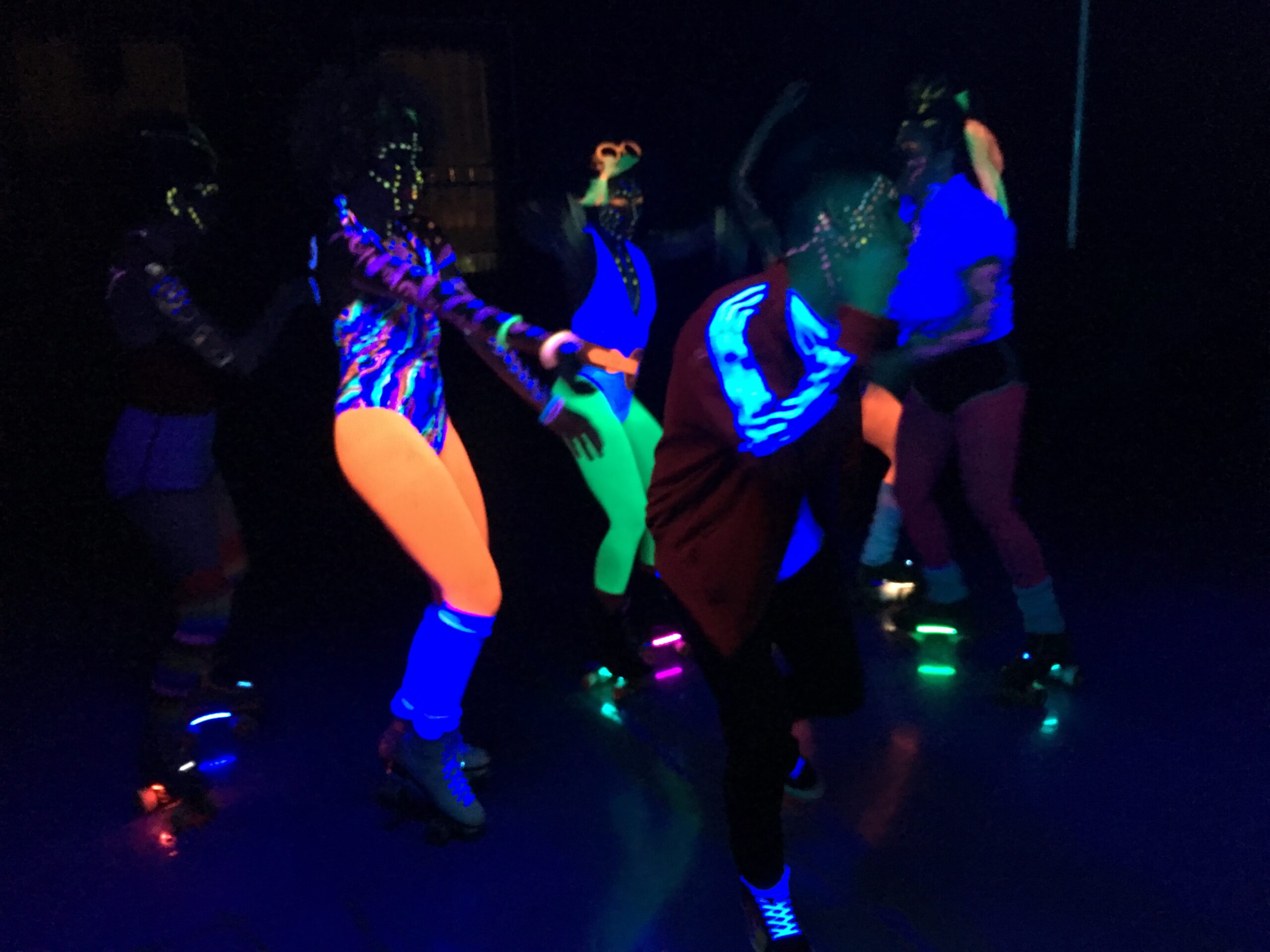 Music Video filming of a group of dancers using neon lights.